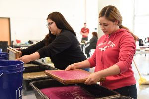 WSU Tri-Cities DREAMers Club students make paper from old field working clothing during a workshop with the Peace Paper Project last year.