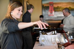 WSU viticulture and enology student Melanie Ford pours a glass of wine during last year's Blended Learning release party at Budd's Broiler.