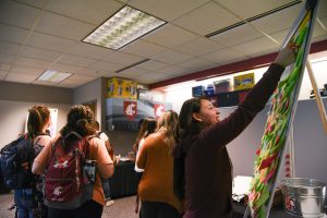 A WSU Tri-Cities student posts up an idea for what to include as a resource for the MOSAIC Center for Student Inclusion during a soft opening event last spring for the center.