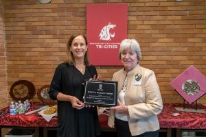 WSU Tri-Cities Chancellor Sandra Haynes and Soroptimist International Three Rivers Current Past President Mary Dover hold a plaque to be installed in the Women's Lounge