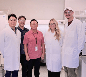 Do-gyun Kim, Miki Santosa, Bin Yang, Katy Andrewjeski, and Zach Johnson pose for a photo in a science lab.