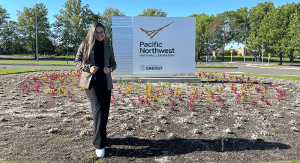 Maria Paula Garcia-Tovar standing in front of a Pacific Northwest National Laboratory sign.
