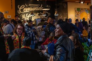 A group of people gather inside of a cafe.