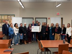 Teachers from Rosalind Franklin STEM Elementary and leadership from WSU Tri-Cities, and the Pasco School District stand with the sign identifying Rosalind Franklin STEM as a WSU Tri-Cities College of Education Laboratory School.