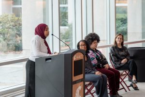WSU Tri-Cities student Razan Osman speaking at a podium in the Floyd Atrium