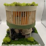Miniature concept of a school with moss and rocks.