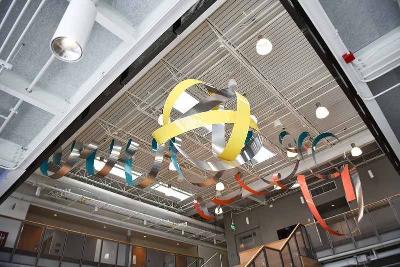 Aluminum multicolored ribbons hanging from the ceiling in Collaboration Hall.