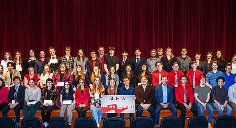 SURCA award winners posed for a photo on stage.