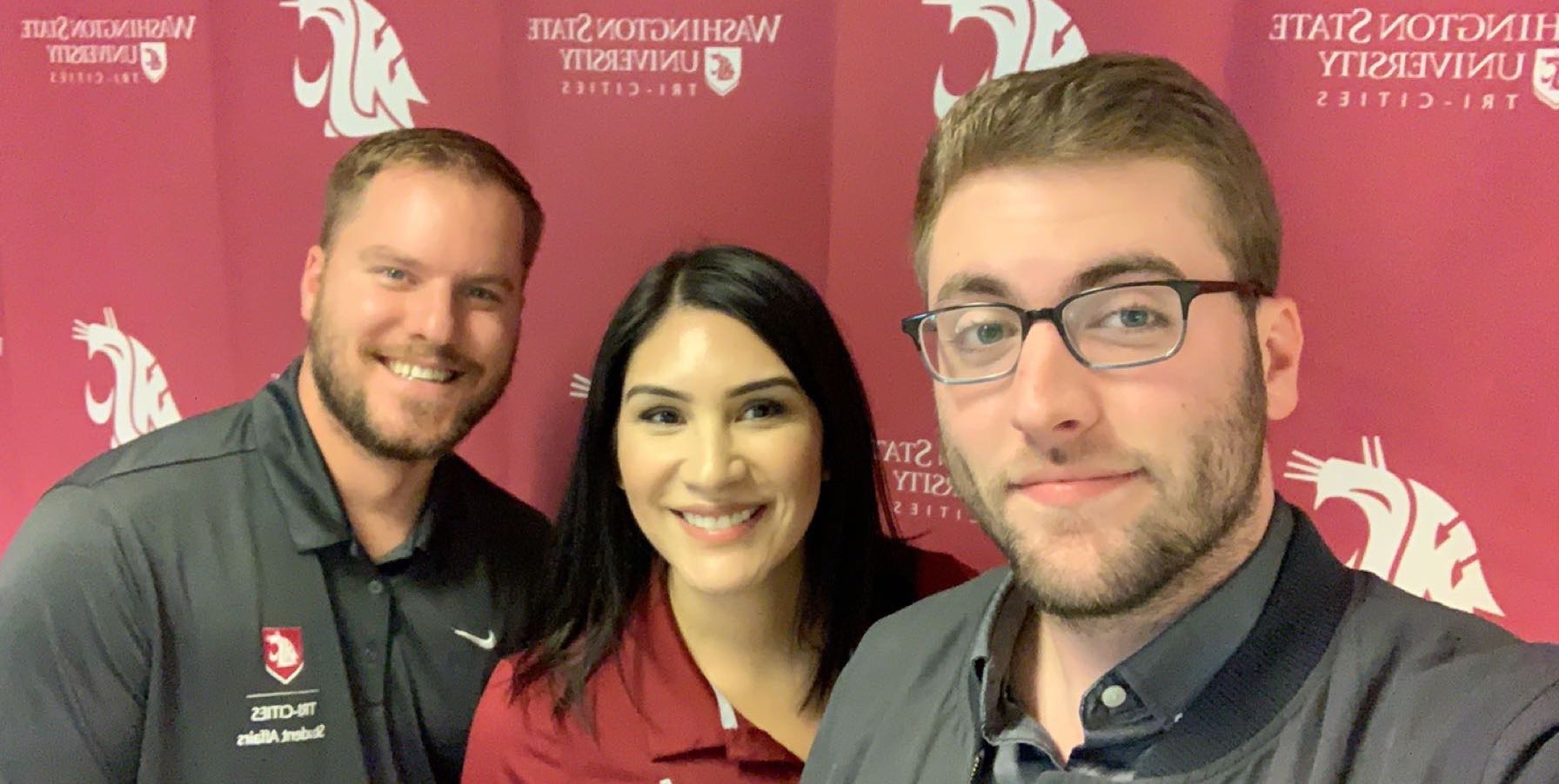 Savanna Kresse posing for photo in front of WSU backdrop with ASWSUTC President Zach Harper and Ian Jamieson