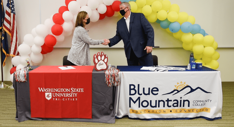 WSU Tri-Cities Chancellor Sandra Haynes, left, shakes hands with BMCC President Mark Browning following the signing of an agreement for a Bridges Transfer Program between the two institutions. Through the program, Oregon students can save thousands on tuition by accessing in-state tuition rates and benefit from a seamless, no-cost transfer process.