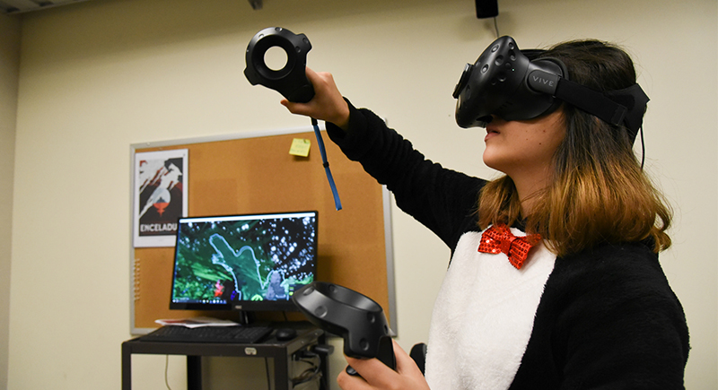 Student Adriana Iturbe paints a tree in an an environment created in virtual reality
