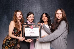 Four people holding a framed certificate that reads, "The 2025 Student Excellence Awards Student Organization of the Year presented to Craft Club."