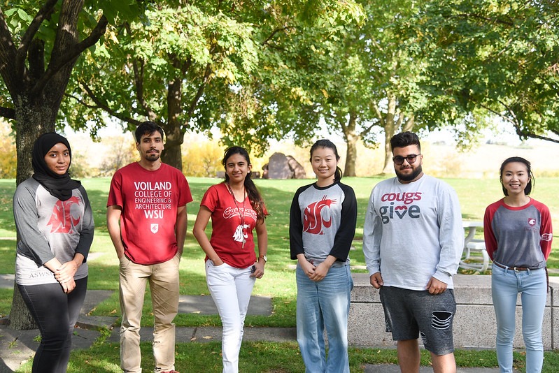 Six international student ambassadors standing outside with trees behind them.