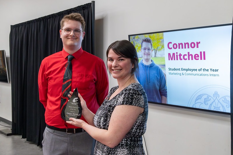 Student Connor Mitchell being presented with the Student Employee of the Year award.