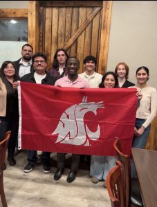 A group of students holding a large crimson WSU flag.
