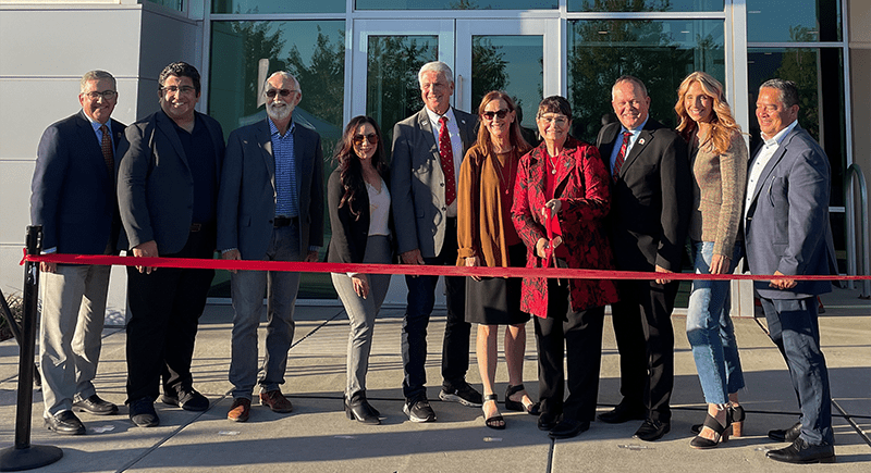 Washington State University President Kirk Schulz, Central Washington Outreach Director from the Office of U.S. Senator Maria Cantwell Richard Evans, Congressman Dan Newhouse, WA State Senator Nikki Torres, WA State Senator Perry Dozier, WSU Tri-Cities Chancellor Sandra Haynes, INEF Inaugural Director and Bob Ferguson Endowed Professor Noel Schulz, WA State Senator Matt Boehnke, WA State Legislative Rep. Stephanie Barnard and WA State Legislative Rep. Alex Ybarra posing with scissors at the ribbon cutting.