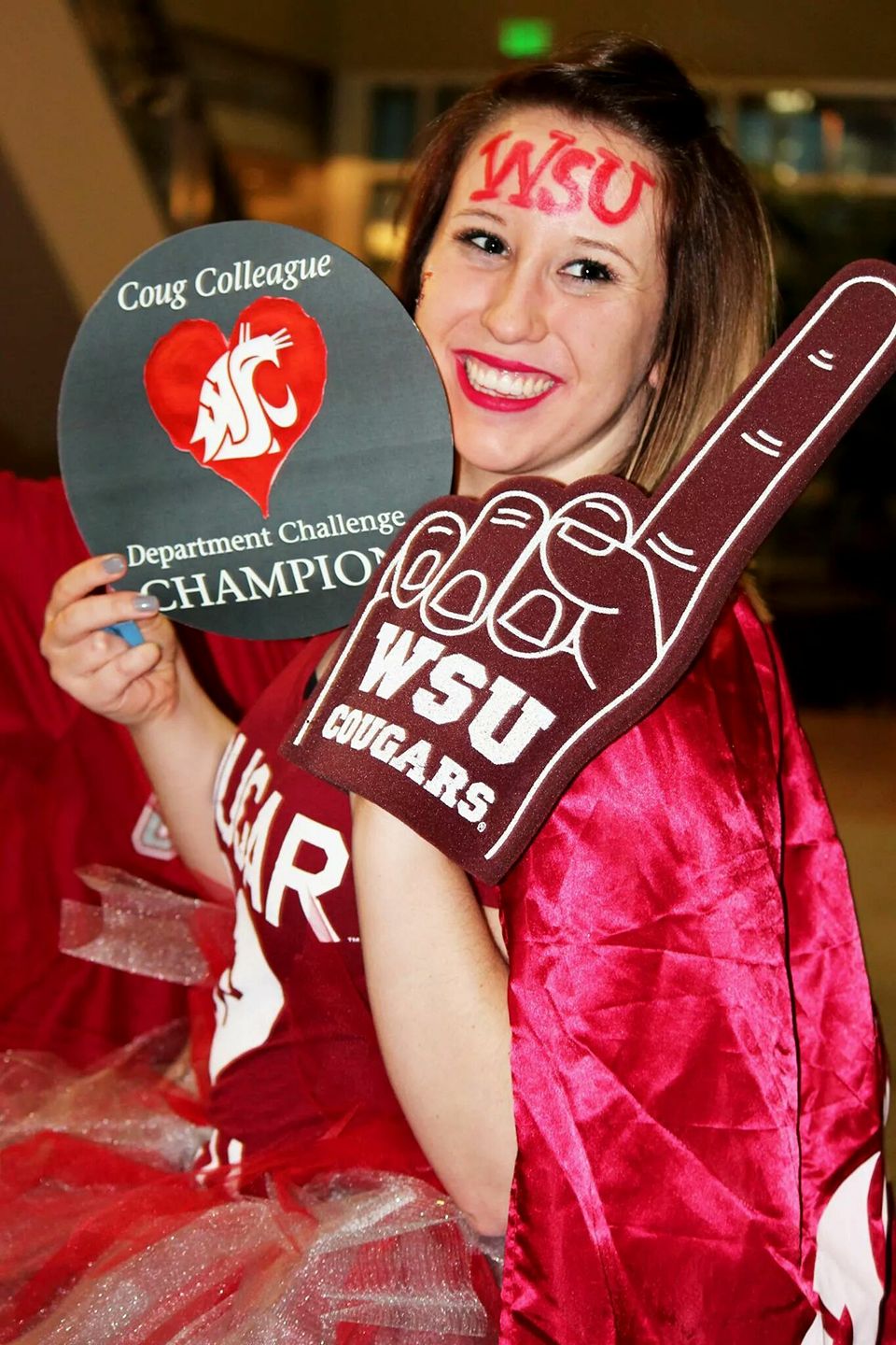 Student Madison Rosenbaum holding a WSU Cougars foam finger